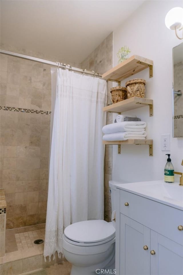 bathroom featuring vanity, toilet, and a shower with shower curtain