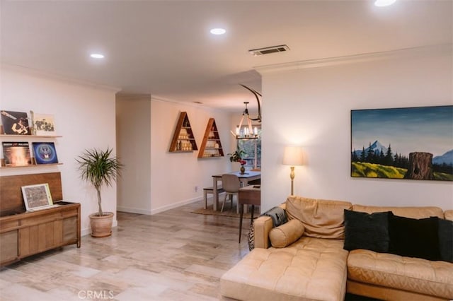 living room featuring light hardwood / wood-style flooring, ornamental molding, and a chandelier