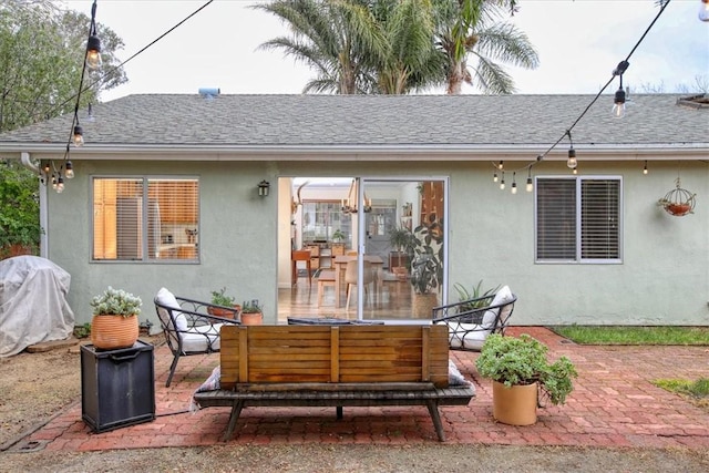 rear view of house with outdoor lounge area and a patio