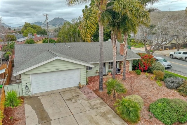 single story home featuring a garage and a mountain view