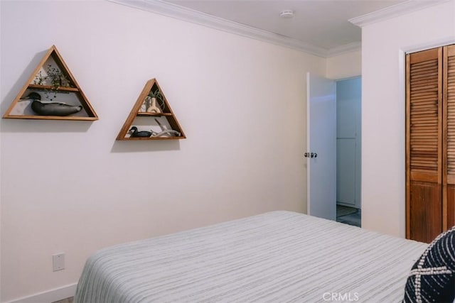 bedroom featuring ornamental molding and a closet