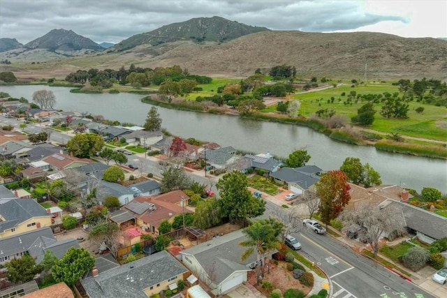 drone / aerial view with a water and mountain view