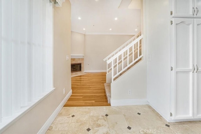 stairway featuring a tiled fireplace and tile patterned floors