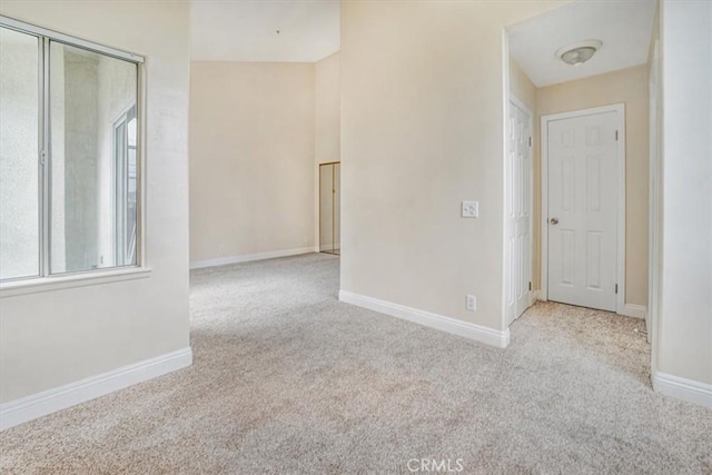 unfurnished room with light carpet