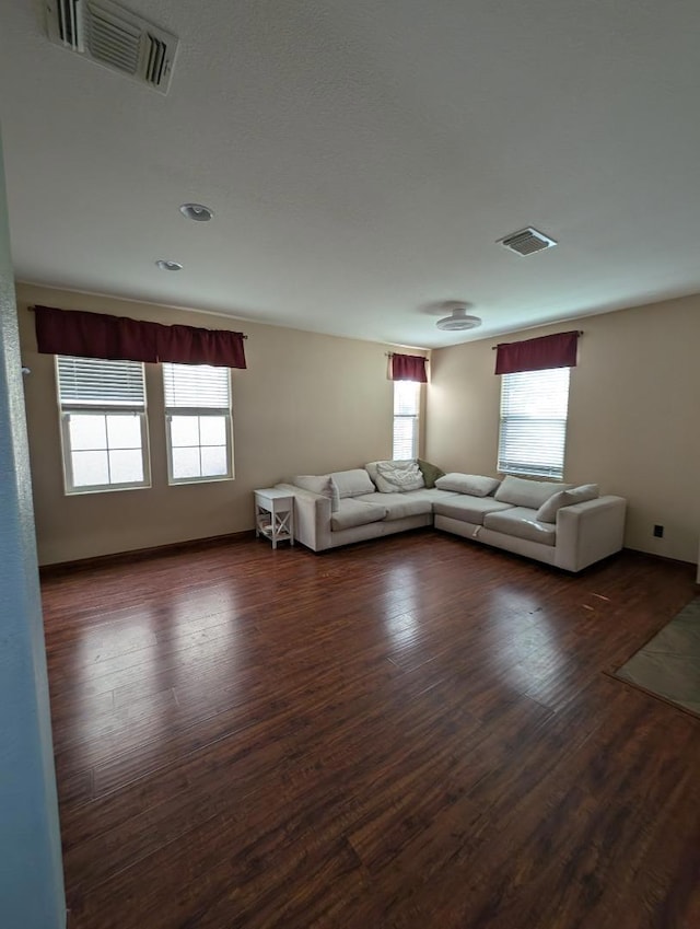 unfurnished living room featuring dark hardwood / wood-style floors