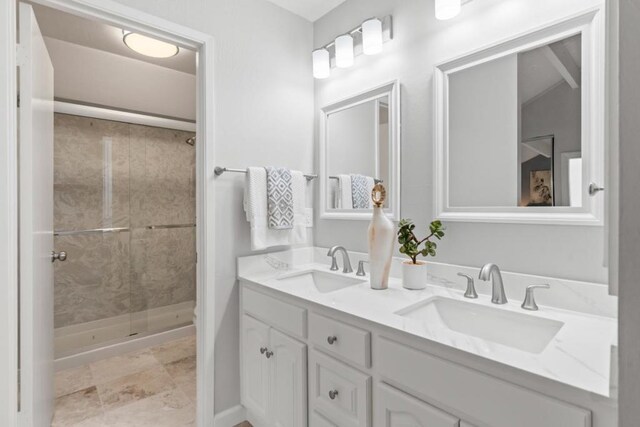 bathroom with tiled shower and vanity