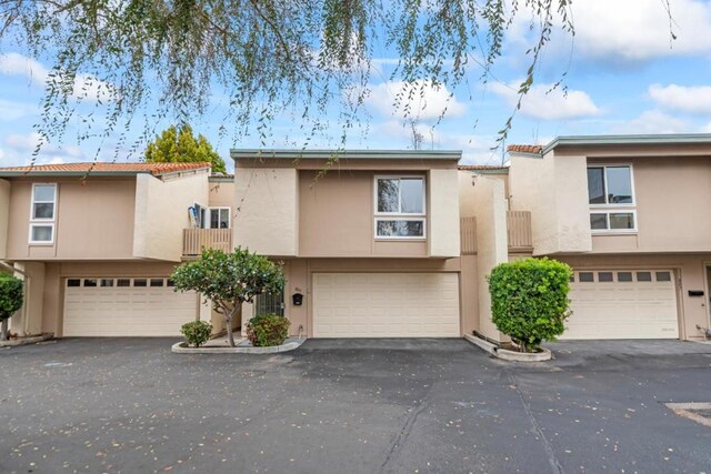 multi unit property featuring a garage