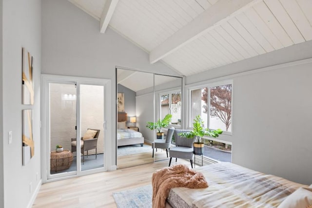 bedroom featuring beamed ceiling, high vaulted ceiling, and light hardwood / wood-style flooring