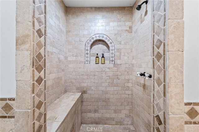 bathroom with tiled shower