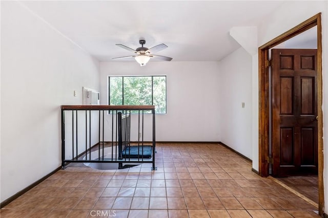 tiled empty room with ceiling fan