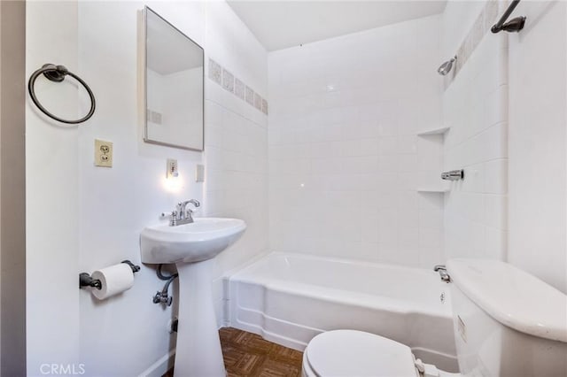 full bathroom featuring tiled shower / bath, parquet flooring, sink, and toilet