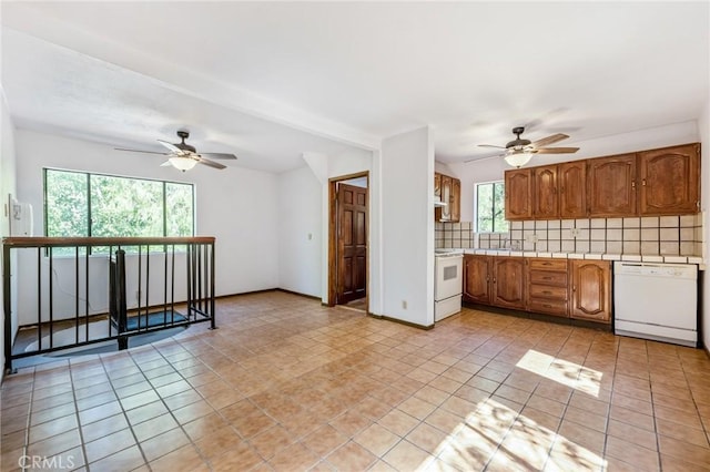 kitchen featuring tasteful backsplash, ceiling fan, light tile patterned floors, and white appliances