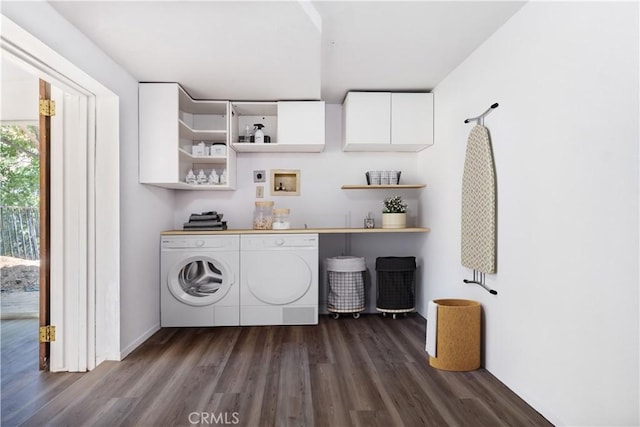 washroom with hookup for a washing machine, dark wood-type flooring, and cabinets