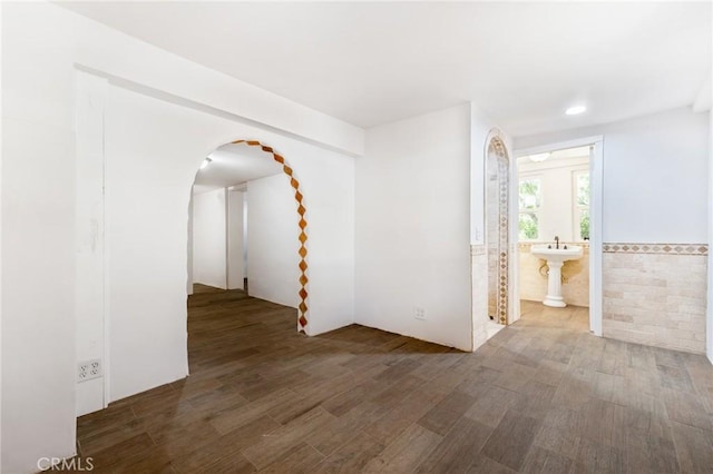 empty room with sink and hardwood / wood-style floors