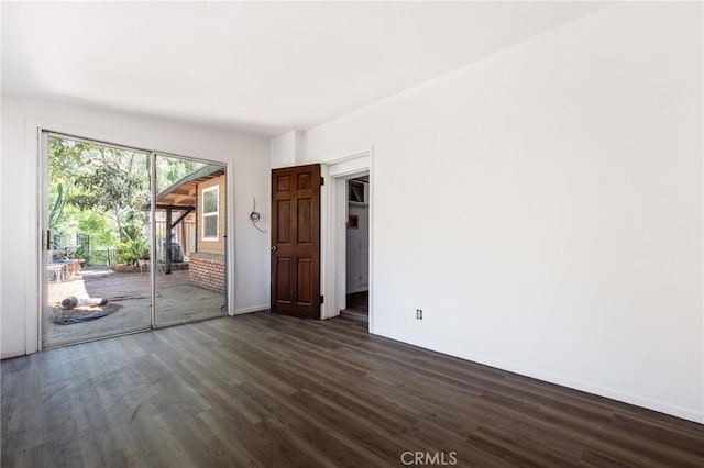 spare room featuring dark hardwood / wood-style floors