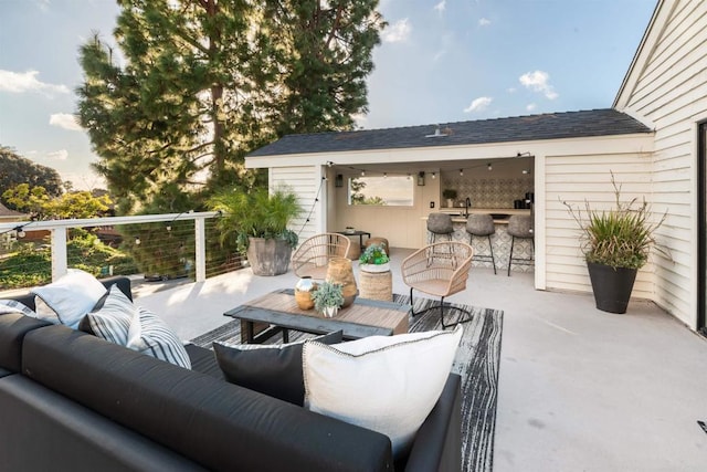 view of patio / terrace with a bar and an outdoor living space