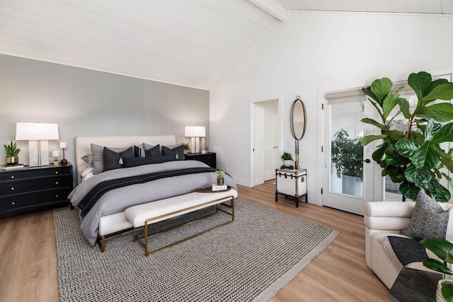 bedroom with beamed ceiling, high vaulted ceiling, and light wood-type flooring