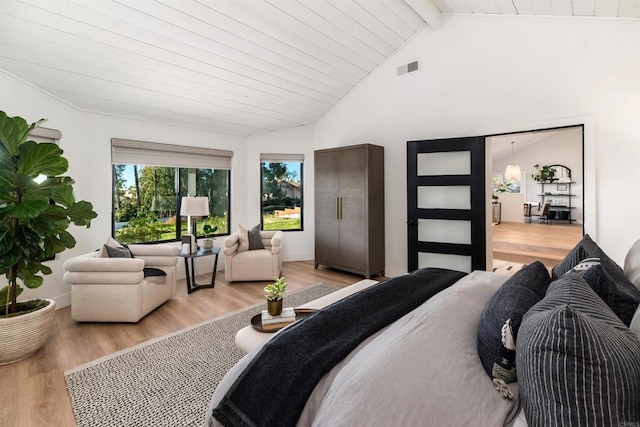 bedroom with wooden ceiling, light hardwood / wood-style floors, and vaulted ceiling with beams