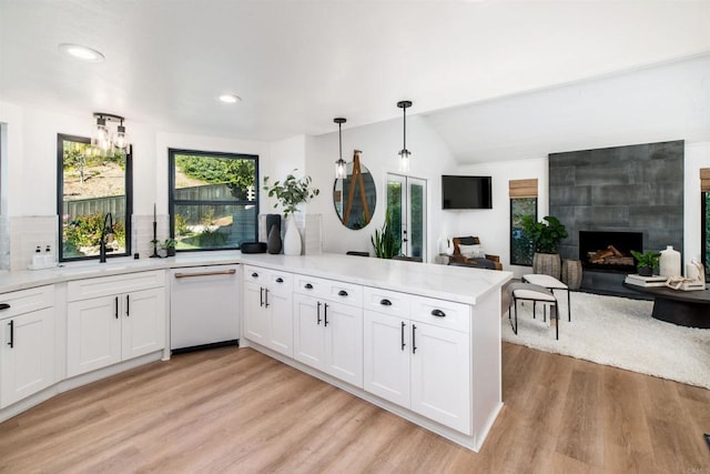 kitchen with dishwasher, kitchen peninsula, hanging light fixtures, and white cabinets