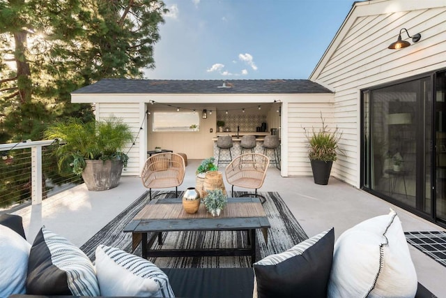 view of patio with an outdoor living space and a bar