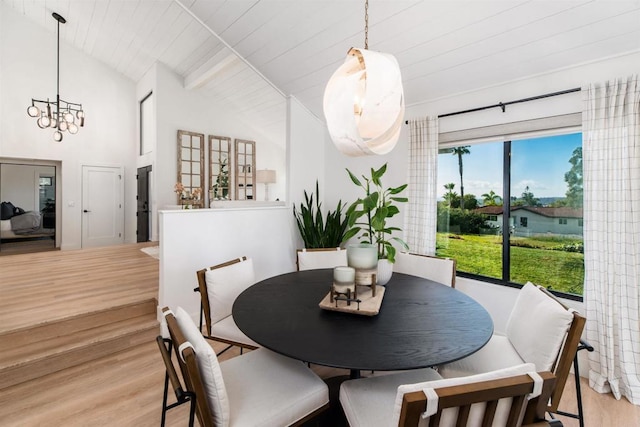 dining area with beamed ceiling, wooden ceiling, high vaulted ceiling, and light wood-type flooring