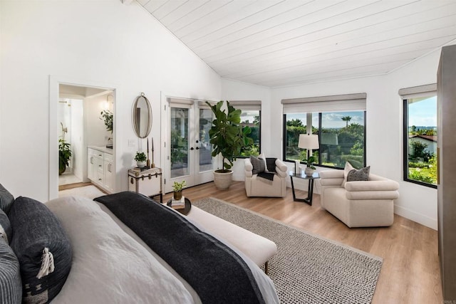 bedroom featuring lofted ceiling, wood ceiling, ensuite bath, access to outside, and light wood-type flooring