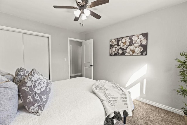 carpeted bedroom with ceiling fan and a closet