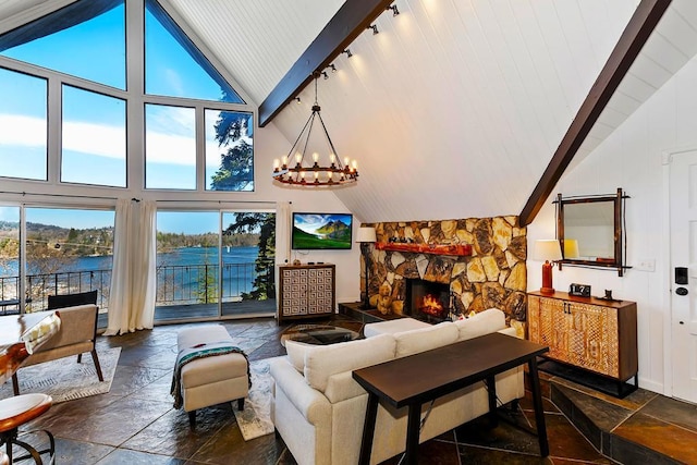 living room with a water view, a chandelier, high vaulted ceiling, beamed ceiling, and a fireplace