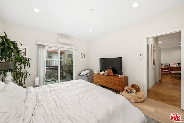 bedroom featuring parquet floors, access to outside, and a wall mounted AC