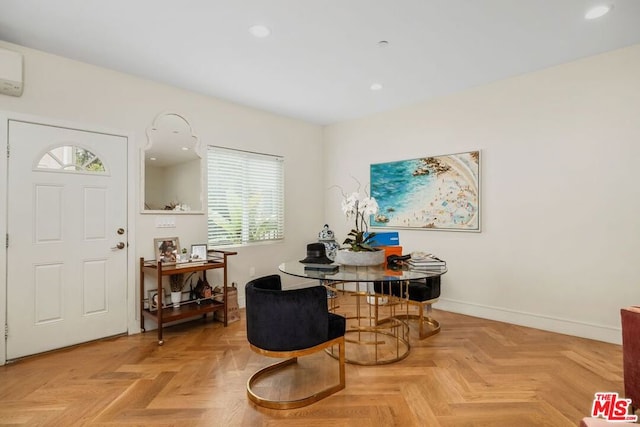 dining room featuring light parquet floors and an AC wall unit