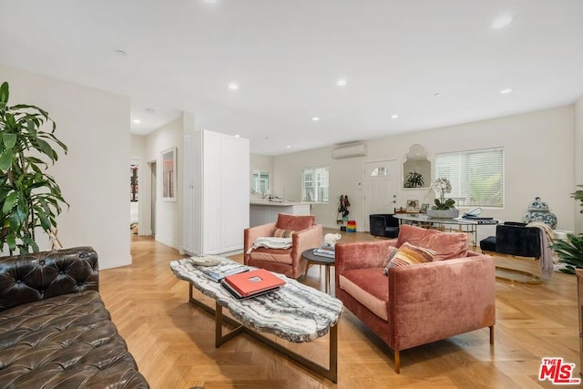 living room with a wall mounted air conditioner and light parquet floors