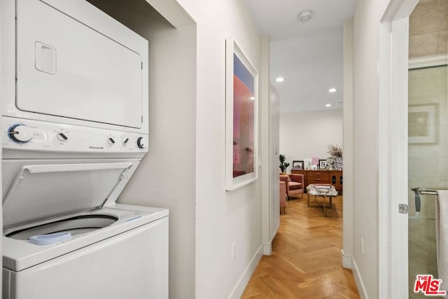 laundry room with stacked washer / dryer and light parquet floors