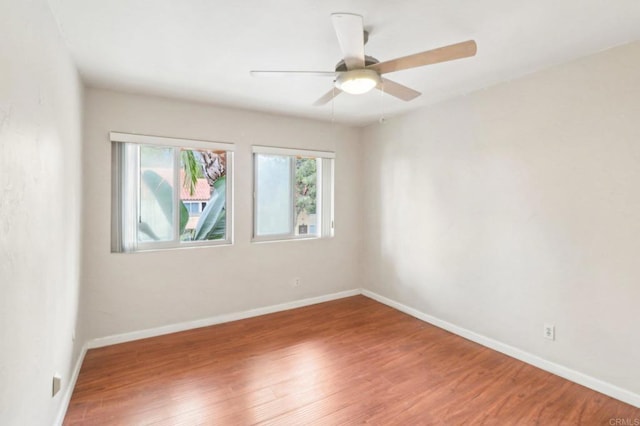 unfurnished room featuring ceiling fan and hardwood / wood-style floors