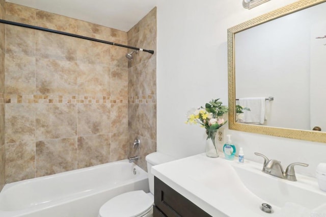 full bathroom with tiled shower / bath combo, vanity, and toilet