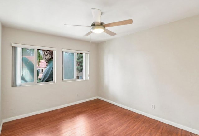 empty room with ceiling fan and hardwood / wood-style floors