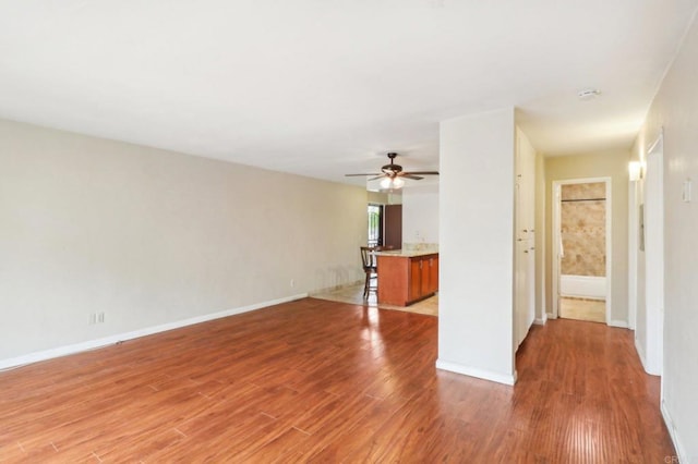 unfurnished living room with hardwood / wood-style floors and ceiling fan