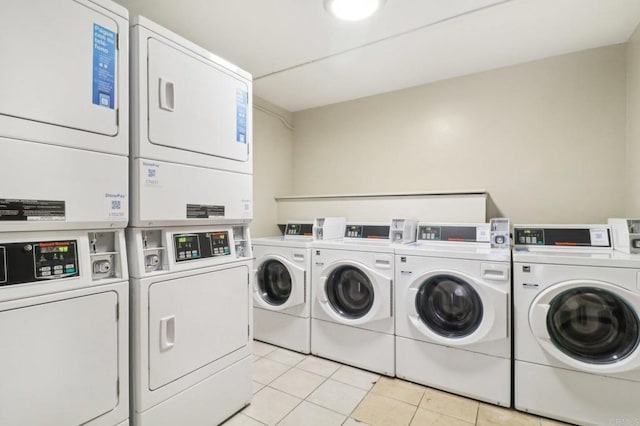 washroom with light tile patterned flooring, stacked washer and dryer, and washer and dryer