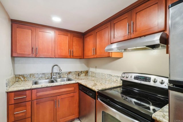 kitchen with sink, light stone countertops, and appliances with stainless steel finishes