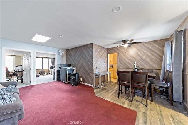 living room featuring ceiling fan and wood-type flooring