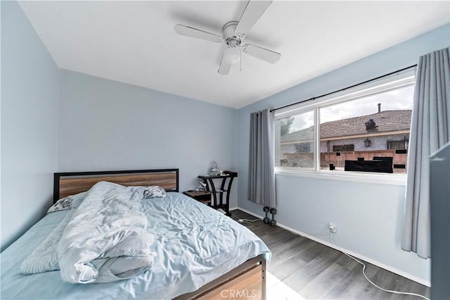 bedroom featuring dark hardwood / wood-style floors and ceiling fan