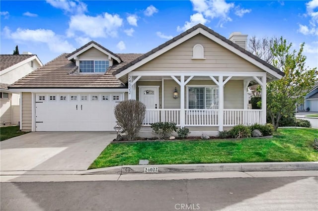 view of front of home with a garage, covered porch, and a front lawn