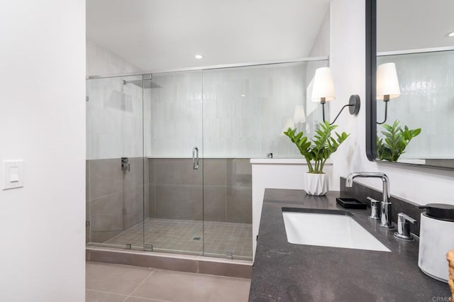 bathroom featuring vanity, a shower with shower door, and tile patterned flooring