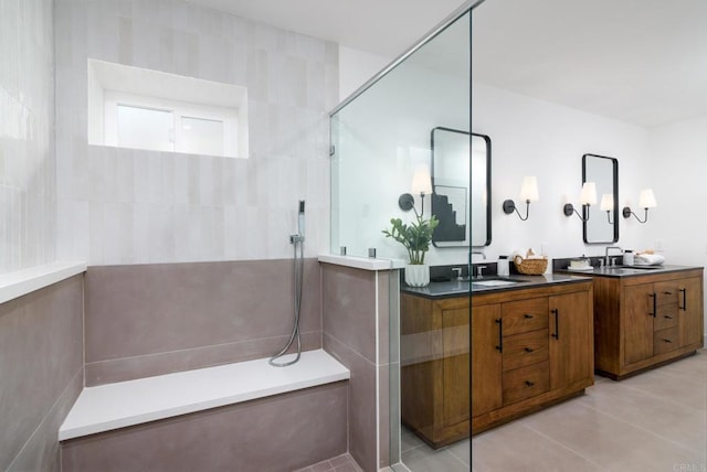 bathroom featuring tiled shower, vanity, and tile patterned floors