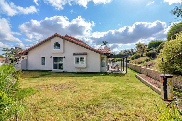 back of house featuring a yard and a pergola