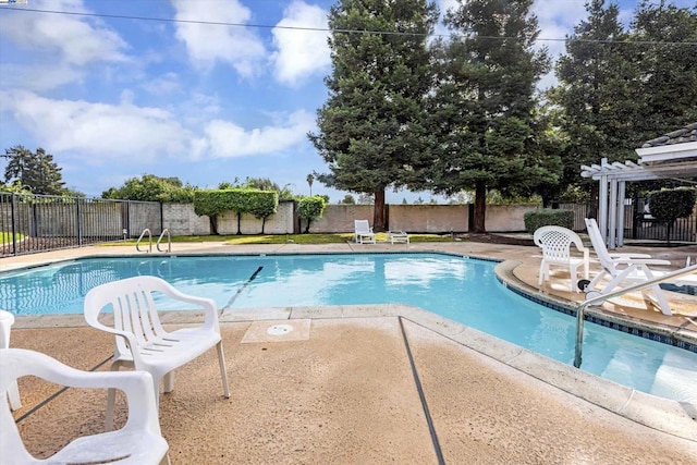 view of swimming pool featuring a patio and a pergola