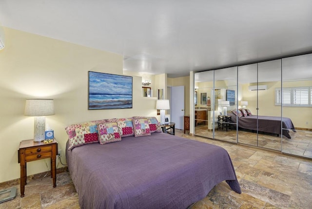 bedroom featuring a wall mounted air conditioner