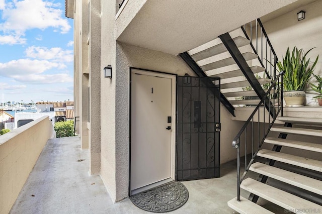 view of exterior entry featuring a balcony