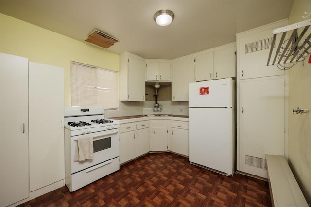 kitchen with white cabinetry, sink, white appliances, and dark parquet flooring