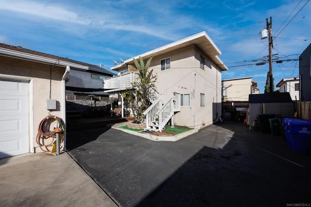 view of front facade with a patio and a storage unit