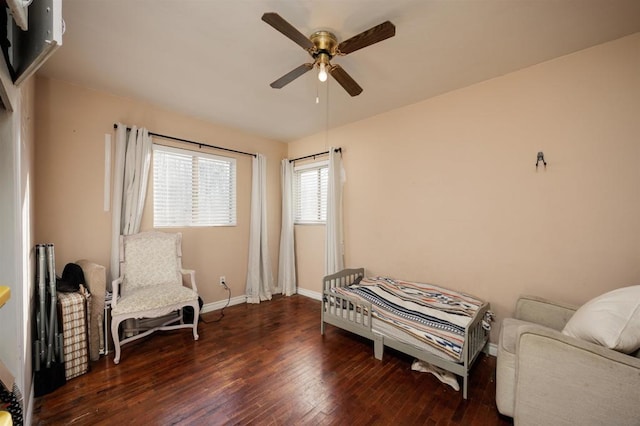 living area with dark wood-type flooring and ceiling fan